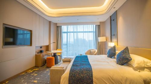 Imagen de la habitación del Hotel YTL OuYue International. Foto 18