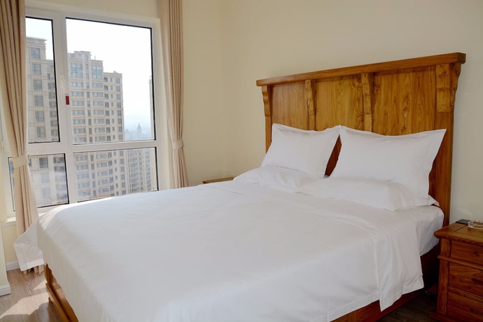 Imagen de la habitación del Hotel Yantai Tianma Xiangcheng Apartment. Foto 10