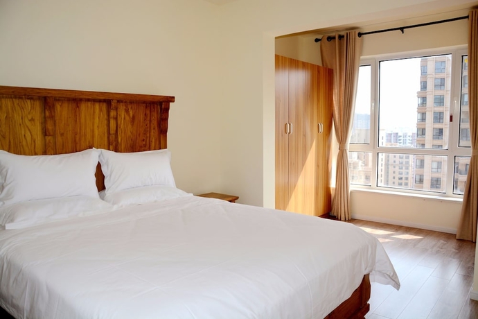 Imagen de la habitación del Hotel Yantai Tianma Xiangcheng Apartment. Foto 13