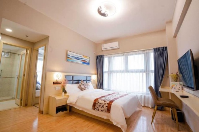 Imagen de la habitación del Hotel Yue Tu Apartment. Foto 13
