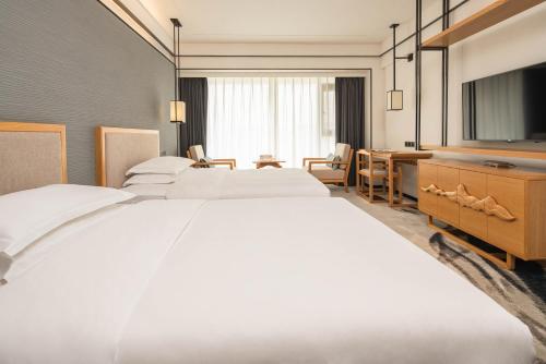 Imagen de la habitación del Hotel Yue Xin Yuan Spa Resort. Foto 19