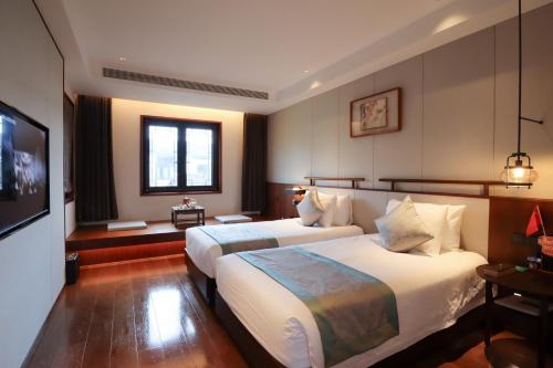 Imagen de la habitación del Hotel Yuyao Yangmingguan. Foto 16