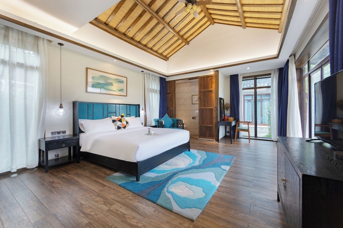 Imagen de la habitación del Hotel Zhangjiajie Ldyllic PondsideTimber Lodge. Foto 2