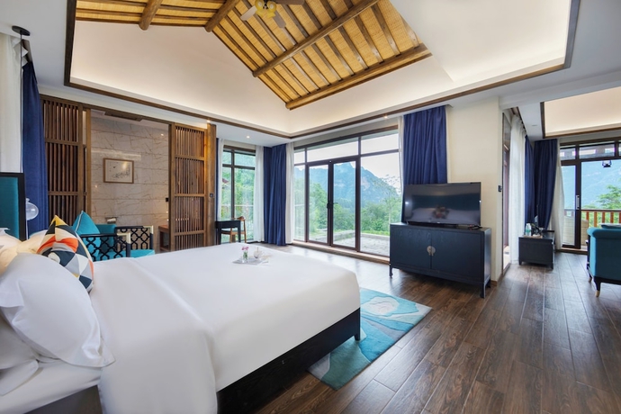 Imagen de la habitación del Hotel Zhangjiajie Ldyllic PondsideTimber Lodge. Foto 3