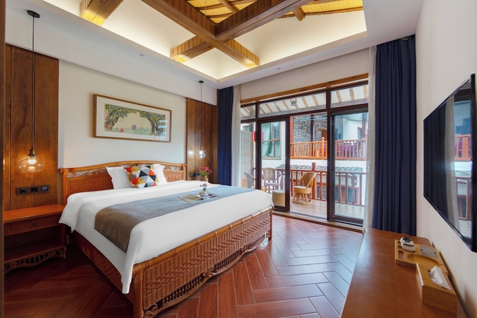 Imagen de la habitación del Hotel Zhangjiajie Ldyllic PondsideTimber Lodge. Foto 4