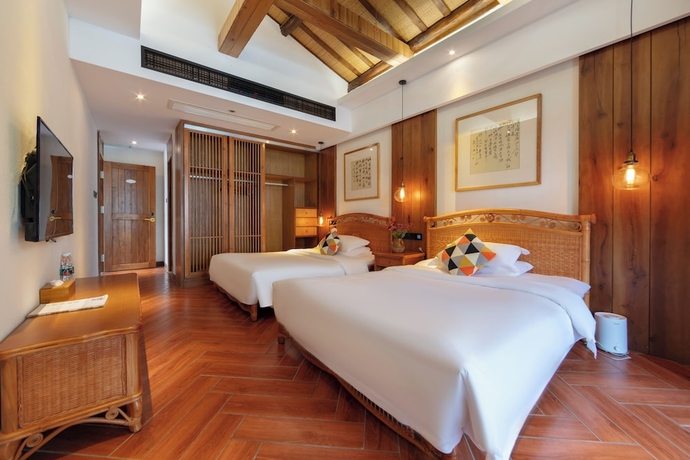Imagen de la habitación del Hotel Zhangjiajie Ldyllic PondsideTimber Lodge. Foto 10