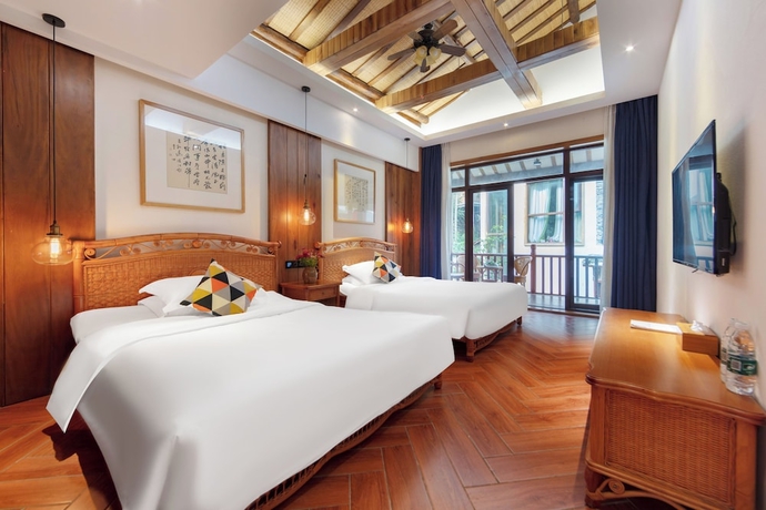 Imagen de la habitación del Hotel Zhangjiajie Ldyllic PondsideTimber Lodge. Foto 11