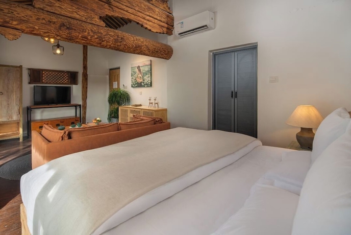 Imagen de la habitación del Hotel lijiangluxianbaomimihuayuankezhan. Foto 5