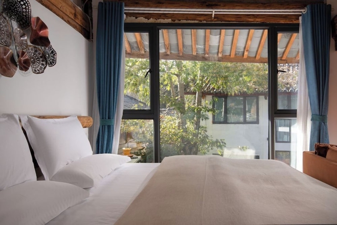 Imagen de la habitación del Hotel lijiangluxianbaomimihuayuankezhan. Foto 8