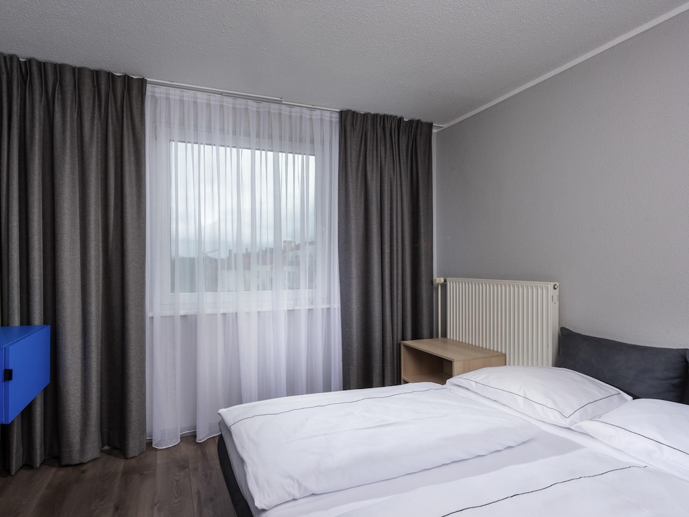 Suite familiar con 2 camas individuales, sofá y cocina del hotel ibis Styles Berlin Treptow. Foto 4