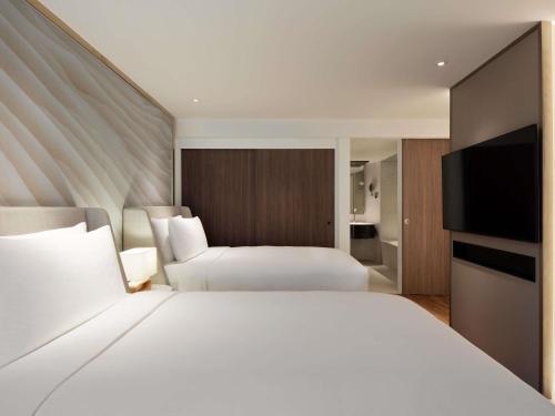 One - Bedroom Family Suite with Twin Beds and Sofa Bed del hotel Mövenpick Bdms Wellness Resort Bangkok. Foto 6