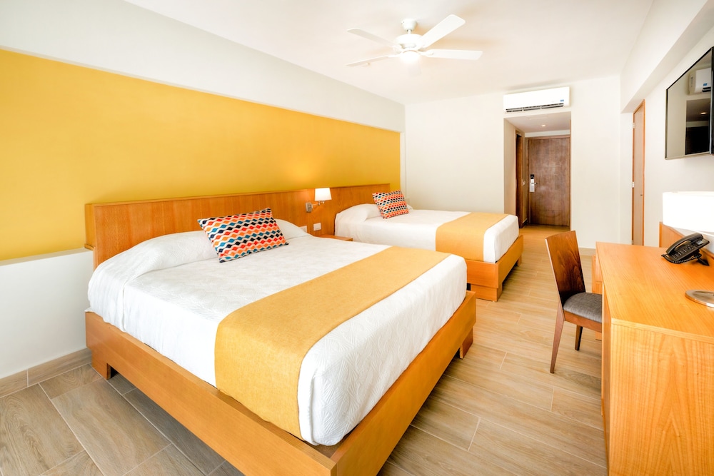 Habitación estándar, 2 camas de matrimonio, vistas al jardín del hotel Coral Costa Caribe Beach Resort - All Inclusive. Foto 1