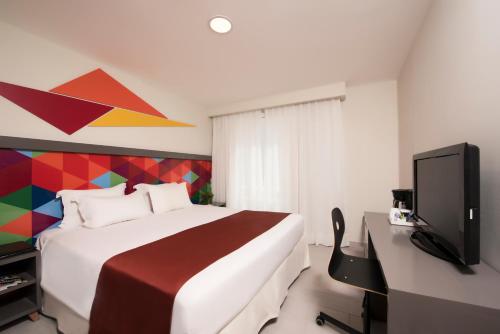 Habitación Deluxe del hotel Novus Plaza Hodelpa. Foto 3