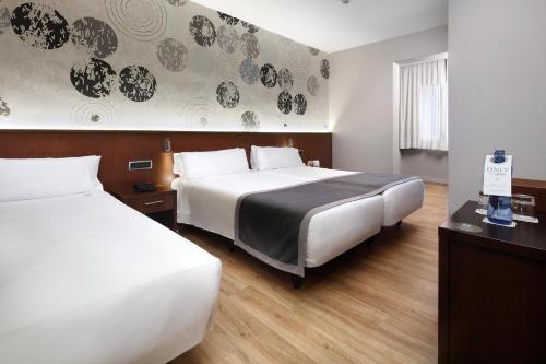 Habitación Doble con cama supletoria - 2 camas del hotel Hcc Taber. Foto 1
