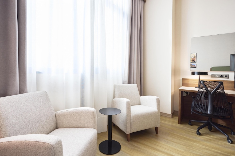 Suite con una habitación King y sala de estar del hotel Hilton Garden Inn Sevilla. Foto 3