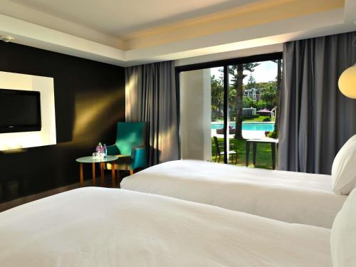 HABITACIÓN ACCESIBLE, 2 camas individuales, vista a la piscina del hotel Pullman Mazagan Royal Golf And Spa. Foto 1