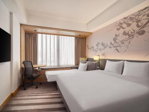 Habitación con cama extragrande y sofá cama del hotel Hilton Garden Inn Singapore Serangoon. Foto 5