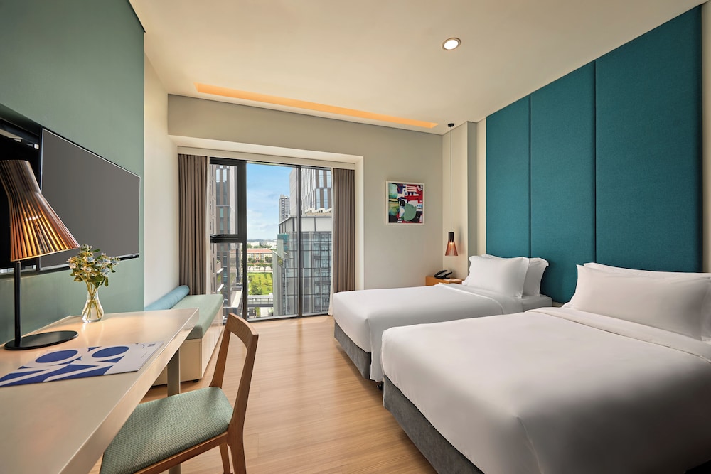 Estudio con 2 camas individuales del hotel Novotel Living Saigon South. Foto 6