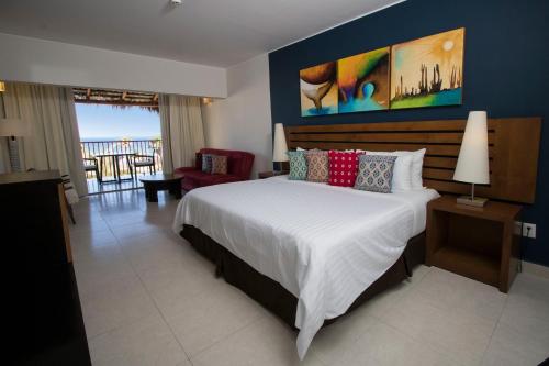 Habitación con cama extragrande y vistas al mar del hotel Grand Decameron Los Cabos, A Trademark All-Inclusive Resort. Foto 2