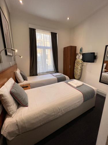 Habitación Doble Estándar - 2 camas del hotel Apollo Kings Cross. Foto 10