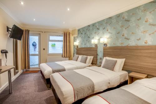 Habitación Cuádruple Deluxe del hotel OYO Bakers London Victoria. Foto 1