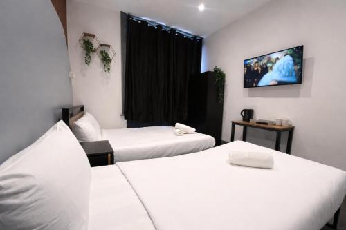 Habitación Triple Deluxe del hotel Oyo Amsterdam. Foto 7