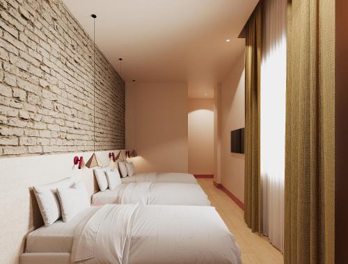Habitación Triple del hotel BYPILLOW Naranjo. Foto 1