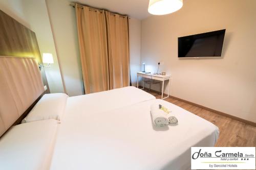 Habitación Doble con cama supletoria del hotel Sercotel Doña Carmela. Foto 1