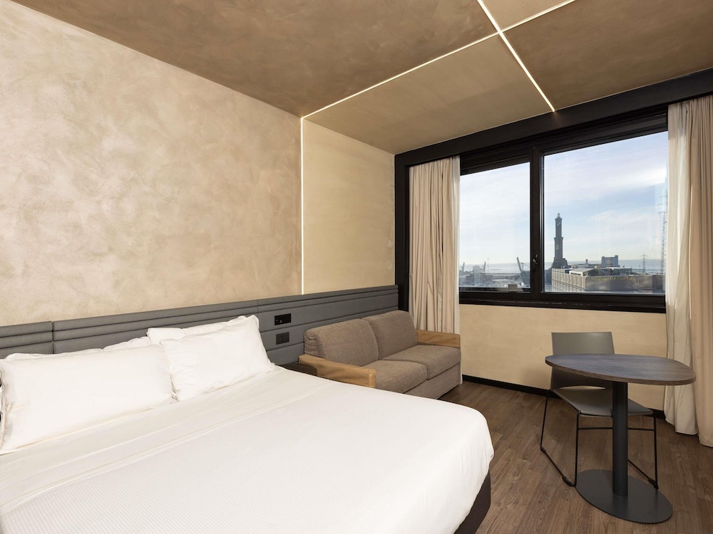 Habitación Superior con una cama doble y un sofá - cama del hotel Novotel Genova City