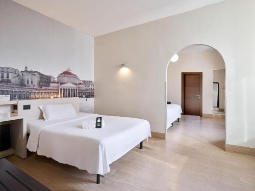 Habitación Triple del hotel B&B Napoli. Foto 2