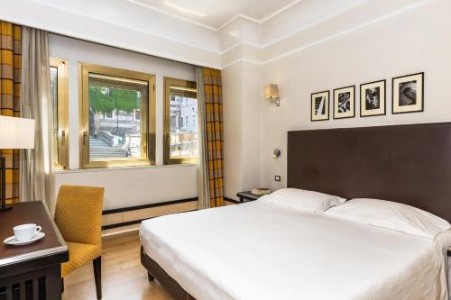 Habitación Triple Clásica del hotel FH55 Grand Hotel Palatino