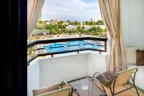 Suite Executive con sofá cama y vistas al jardín y a la piscina - Cama extragrande del hotel Fes Marriott Jnan Palace. Foto 3