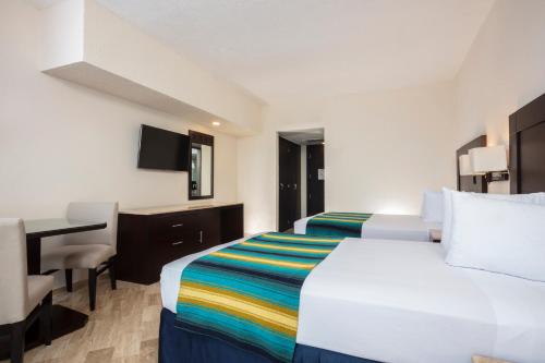 Habitación Doble - 2 camas dobles del hotel Crown Paradise Club Cancun All Inclusive. Foto 2