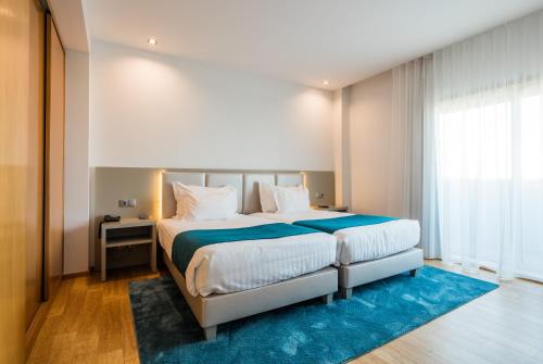 Suite 2 habitaciones 1 Cama Individual 1 Cama doble del hotel Opohotel Porto Aeroporto. Foto 4
