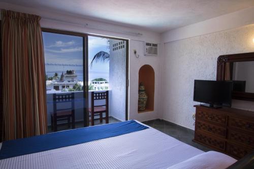 Habitación Estándar - 1 cama extragrande del hotel Decameron Los Cocos Guayabitos, Ramada All-Inclusive Resort. Foto 1