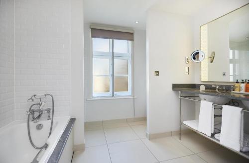 Habitación con dos camas dobles del hotel The Waldorf Hilton, London. Foto 1