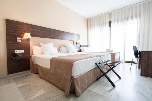 Habitación Doble con cama supletoria del hotel DWO Finca Los Abetos. Foto 1