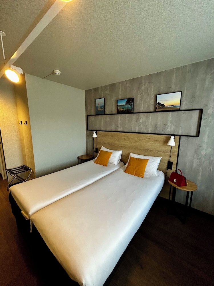 Habitación con dos camas individuales equipada con nueva ropa de cama del hotel Ibis Saint Malo La Madeleine. Foto 6