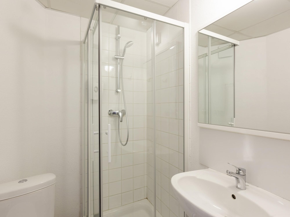 Habitación con una cama doble y baño del hotel F1 Reims Tinqueux. Foto 6