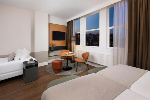 Habitación Triple Estándar con vistas a la ciudad del hotel Nh City Centre Amsterdam