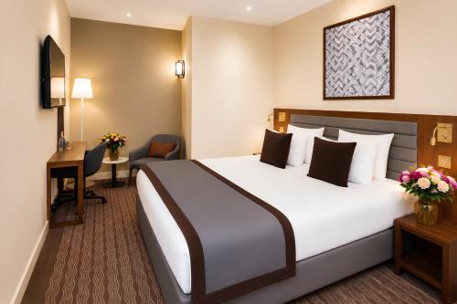 Suite Junior con cama doble grande y sofá cama del hotel Mayflower Opéra. Foto 1