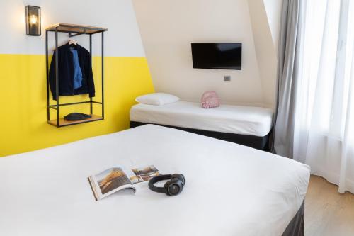 Habitación Triple Estándar con 2 camas individuales y sofá cama del hotel Ibis Styles Paris Nation Porte De Montreuil. Foto 6