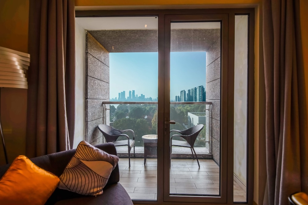 Habitación Deluxe con Dos Camas Individuales y Balcón del hotel Novotel Suzhou Sip. Foto 1
