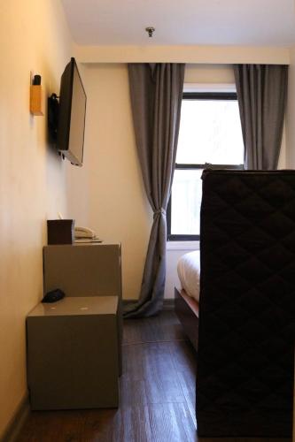 Habitación Individual con baño del hotel Midtown West. Foto 3