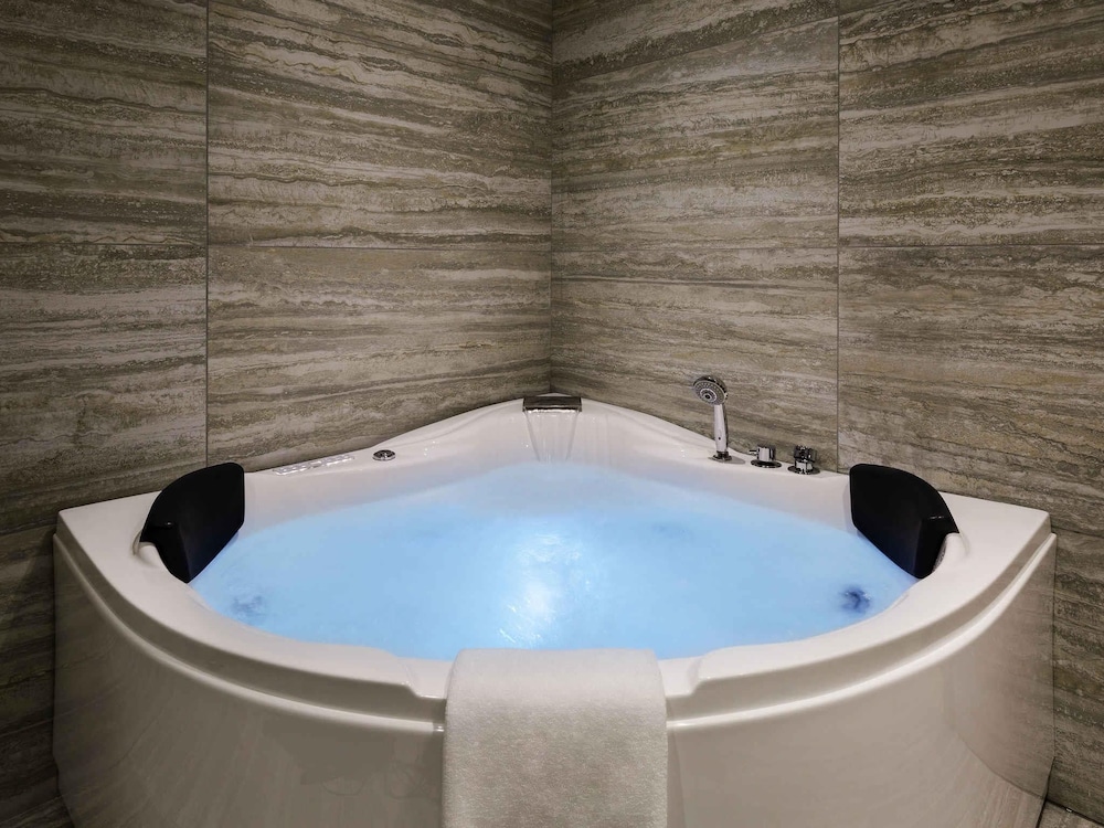 Suite Ejecutiva con 1 cama king size y 1 sofá del hotel Novotel Jeddah Tahlia