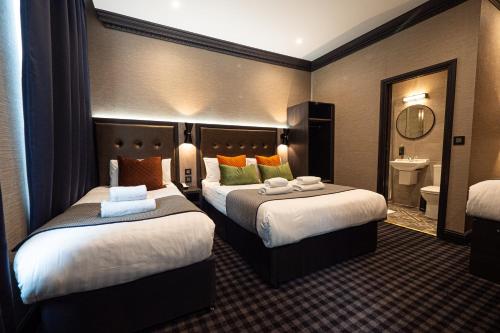 Habitación Doble con cama supletoria del hotel The House Of Toby. Foto 2