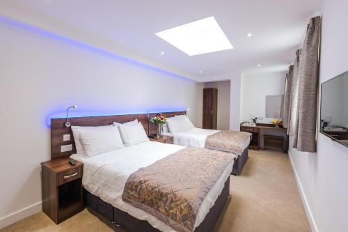 Habitación Cuádruple Deluxe del hotel Signature London. Foto 6