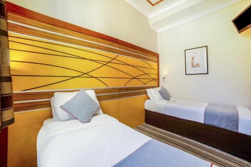 Habitación Doble Estándar - 2 camas del hotel Oyo Vegas. Foto 3