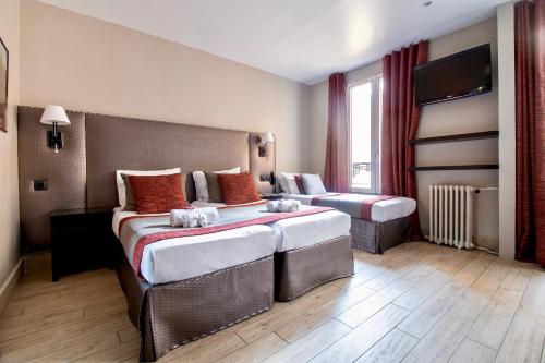 Habitación Cuádruple del hotel Migny Opera Montmartre. Foto 11