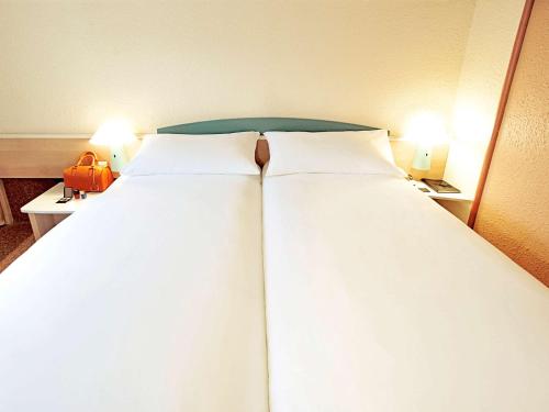 Habitación Doble Estándar - 2 camas del hotel Ibis Strasbourg Aéroport Le Zenith. Foto 1